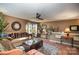 Spacious living room featuring hardwood floors, plush sofa, and a ceiling fan at 12413 Stowe Acres Dr, Charlotte, NC 28262