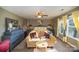 Main bedroom with a king-size bed, sitting area, and large windows at 12413 Stowe Acres Dr, Charlotte, NC 28262