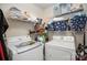Convenient laundry room with washer, dryer, and shelving for storage at 12413 Stowe Acres Dr, Charlotte, NC 28262