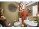 Stylish bathroom with unique decor and a pedestal sink at 12413 Stowe Acres Dr, Charlotte, NC 28262
