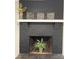 Black brick fireplace with decorative mantle and framed artwork at 143 White Farm Rd, Dallas, NC 28034