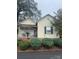 Adorable yellow cottage, showcasing a porch and neat landscaping at 2 Elm St, Lancaster, SC 29720