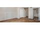 Open living room with wood-look flooring, white walls, and closet at 3312 Heathstead Pl, Charlotte, NC 28210