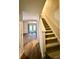 Carpeted stairway with wood-look flooring in adjacent room at 3312 Heathstead Pl, Charlotte, NC 28210