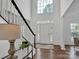 Elegant entryway with hardwood floors, a view of the front door, and a staircase at 7605 Berryfield Ct, Waxhaw, NC 28173