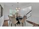 Formal dining room features a round table, chandelier, and hardwood floors at 7605 Berryfield Ct, Waxhaw, NC 28173