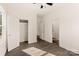 Well-lit bedroom with wood-look floors and access to hallway at 9000 Boyd Dr, Matthews, NC 28105