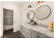 Bathroom with double vanity, marble countertop, and large circular mirrors at 9000 Boyd Dr, Matthews, NC 28105