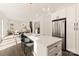 Modern kitchen with island seating and stainless steel appliances, open to living area at 9000 Boyd Dr, Matthews, NC 28105