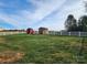Spacious backyard with storage sheds and a white fence at 129 Burning Ln, Stony Point, NC 28678
