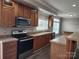 Spacious kitchen with wood cabinets, stainless steel appliances, and an island at 129 Burning Ln, Stony Point, NC 28678