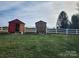 Two storage sheds in backyard with white fence at 129 Burning Ln, Stony Point, NC 28678