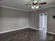 Neutral-toned bedroom with hardwood floors and ceiling fan at 129 Burning Ln, Stony Point, NC 28678