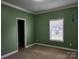 Green-walled bedroom with carpeted floor and a window at 129 Burning Ln, Stony Point, NC 28678