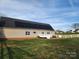 House back view, featuring solar panels and deck at 129 Burning Ln, Stony Point, NC 28678