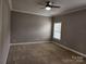 Carpeted bedroom with window and ceiling fan at 129 Burning Ln, Stony Point, NC 28678