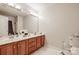 Shared bathroom with double vanity and shower/tub at 14232 Kendalton Meadow Dr, Mint Hill, NC 28227