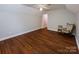 Bright bedroom featuring wood floors and access to hallway at 14232 Kendalton Meadow Dr, Mint Hill, NC 28227