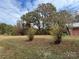 Spacious backyard with mature trees and open grassy area at 180 Tower Rd, Troy, NC 27371