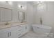 Elegant bathroom with double vanity, soaking tub, and gold fixtures at 2410 Brantley Rd, Kannapolis, NC 28083