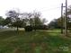 Spacious backyard with large grassy area and mature trees at 801 Anderson Rd, Albemarle, NC 28001