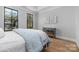 Well-lit bedroom with hardwood floors and modern dresser at 1162 S Kings Dr, Charlotte, NC 28207