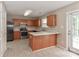 Kitchen with wood cabinets, stainless steel appliances, and breakfast bar at 1312 Crestfield Ct, Charlotte, NC 28269