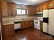 Kitchen with wood cabinets, white appliances, and tile floor at 1507 Springhaven Cir, Albemarle, NC 28001