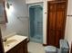 Bathroom with shower stall, toilet, sink, and wood cabinets at 1507 Springhaven Cir, Albemarle, NC 28001