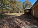 Large backyard with brick patio and wooded area at 1507 Springhaven Cir, Albemarle, NC 28001