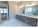 Double vanity bathroom with marble flooring and a large mirror at 1865 Rock Hill Church Rd # 3, Matthews, NC 28104