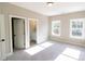 Bright bedroom with carpet, two windows, and an attached bathroom at 1865 Rock Hill Church Rd # 3, Matthews, NC 28104