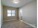 Bedroom with carpet, window, and attached bath at 1865 Rock Hill Church Rd # 3, Matthews, NC 28104
