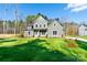 Two-story house with gray siding, white trim, and a large front yard at 1865 Rock Hill Church Rd # 3, Matthews, NC 28104