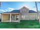 Two-story house with gray siding and a covered patio at 1865 Rock Hill Church Rd # 3, Matthews, NC 28104