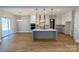 Open concept kitchen with island, white cabinets, and gray lower cabinets at 1865 Rock Hill Church Rd # 3, Matthews, NC 28104