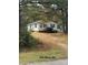 White ranch home with maroon trim and pine trees at 220 Woodside Dr, Wadesboro, NC 28170