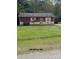 Small maroon house with a grassy front yard at 220 Woodside Dr, Wadesboro, NC 28170