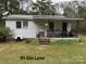 White mobile home with front porch at 220 Woodside Dr, Wadesboro, NC 28170