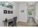 A long hallway with a small workspace and natural light at 4147 Merlane Dr, Charlotte, NC 28206