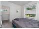 Grey bedroom with large windows overlooking backyard at 4147 Merlane Dr, Charlotte, NC 28206