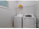Laundry room with washer, dryer, and shelving at 4147 Merlane Dr, Charlotte, NC 28206