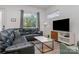 Living Room with black leather sectional and TV at 4147 Merlane Dr, Charlotte, NC 28206