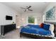 Main bedroom with blue bedding and large window at 4147 Merlane Dr, Charlotte, NC 28206
