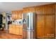 Stainless steel refrigerator in a kitchen with oak cabinets at 4298 Maiden Hwy, Lincolnton, NC 28092