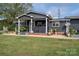 Dark gray house with a covered porch, landscaping, and a large yard at 4298 Maiden Hwy, Lincolnton, NC 28092