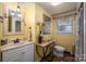 Clean bathroom with white vanity and yellow walls at 4298 Maiden Hwy, Lincolnton, NC 28092