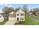 Two-story house with attached garage and front yard at 7633 Shiny Meadow Ln, Charlotte, NC 28215