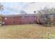 Brick exterior with a deck, surrounded by a grassy lawn at 8724 Old Plank Rd, Charlotte, NC 28216