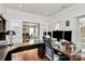 Home office with hardwood floors, built-in shelving, and view of dining room at 16404 Grassy Creek Dr, Huntersville, NC 28078